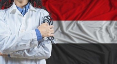 Healthcare professional with Yemen flag background. Professional doctor holding stethoscope on