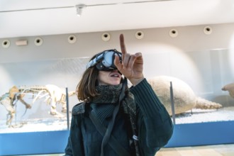 Woman wearing a vr headset interacting with virtual elements and exploring an augmented reality