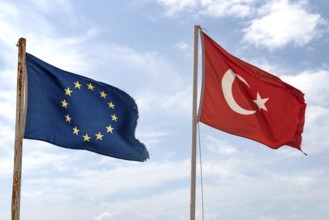 The flag of the European Union flying beside the Turkish flag on a beach in Alanya on the