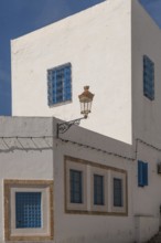 Classic white washed walls and blue painted windows of Tunisian architecture in the UNESCO world