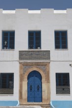 The beautiful blue ornate door and architecture of the Abbasid School inside the Medina of Sfax,