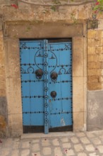 A blue wooden door, traditional local architecture in the Medina of Tunis, a UNESCO designated
