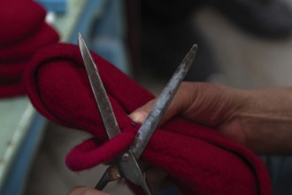 Tunis, Tunisia 22nd May, 2024 A Tunisian artisan puts the finishing touches to a red Chechia in