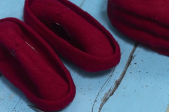 A Tunisian artisan puts the finishing touches to a red Chechia in Souk Ech-Chaouachine, part of the