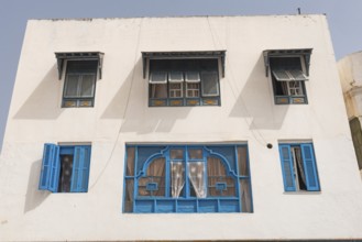 Classic white washed walls and blue painted windows of Tunisian architecture in the UNESCO world