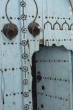 An open old blue wooden door, traditional local architecture in the Medina of Tunis, a UNESCO