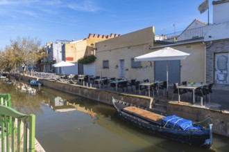 El palmar fishing village showcasing a narrow canal with traditional boats, a row of charming