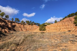 Las arcillas natural park in teruel shows vivid red clay badlands and eroded canyons topped with
