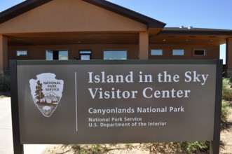 Island in the Sky Visitor Center sign in Canyonlands National Park in front of the center,