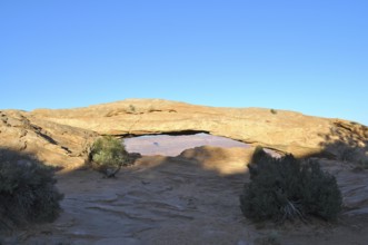 Mesa Arch forms a natural passageway in the desert landscape, Canyonlands National Park, Island in