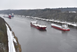 Ships sail in winter during snowfall in the Kiel Canal, NOK, Kiel Canal, Schleswig-Holstein,