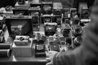Hand of a customer, Photographica, old photo equipment, cameras, lenses, display, black and white,