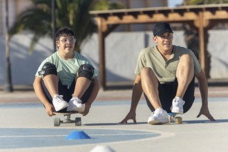 A Down syndrome teenager and his brother practice sports together, enjoying skateboarding outdoors