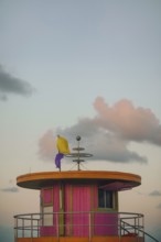 A picturesque view of a vibrant, colorful lifeguard tower on Miami Beach, captured under a softly