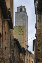 A striking view of San Gimignano's iconic medieval towers framed by narrow streets and traditional