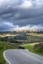 A scenic view of Pienza from the main road in Val d Orcia, Tuscany. The winding road cuts through