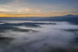 A stunning aerial view of the Val d Orcia in Tuscany, Italy, with rolling hills blanketed in