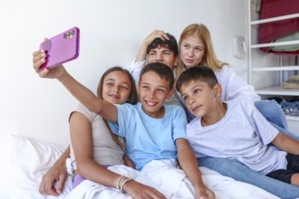 A teenage girl and young man with blond hair and lighter skin, likely older siblings, join a girl