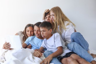 A heartwarming family portrait featuring an older brother and sister enjoying a fun moment with