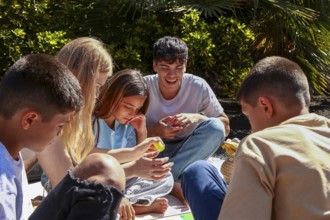 An older brother and sister enjoy time with their younger triplet siblings, two boys and a girl, in