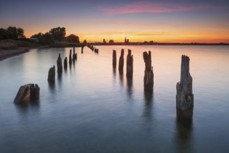 View at sunset over the Strelasund of the skyline of the city of Stralsund with its churches and