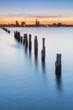 View at sunset over the Strelasund of the illuminated silhouette of the city of Stralsund with its