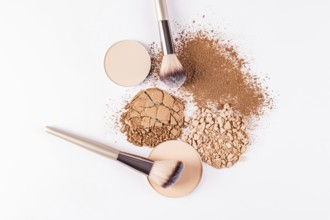 Top view image showcasing a selection of makeup powders including compact and loose varieties,