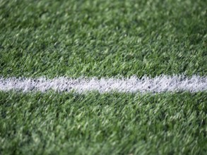 Detailed shot of a soccer field, highlighting the contrast between the vibrant green grass and a