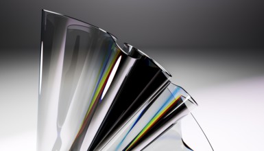 A close up of a sleek glass sculpture showcasing a stunning reflective prism effect. The dynamic