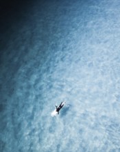 A captivating surf session in Portugal showcasing surfers navigating clear blue water. The image