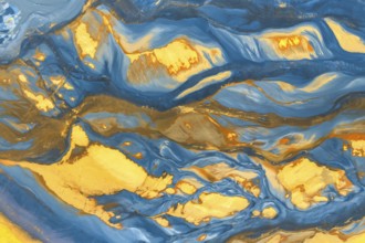 This image captures a stunning blend of swirling blue and gold hues, creating an abstract texture