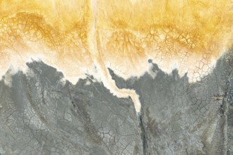 Captivating multicolored mud texture showcasing vibrant orange and gray hues The cracked surface