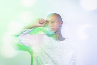 A serene image of a middle-aged woman with a shaved head, wearing a textured white top against a