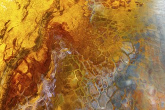 A vivid image showcasing a multicolor mud surface with intricate textures and abstract patterns The