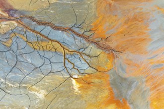 Aerial perspective of vibrant multicolor mud patterns and textures The image showcases natural,