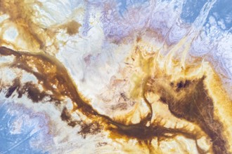 A vibrant abstract texture blending earthy browns and celestial blues, evoking landscapes and