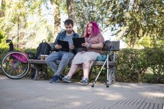 A college couple sits on a bench, studying with clipboards The woman, managing a disability due to