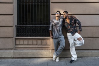 A latin gay couple enjoys the sunny weather in Madrid, exuding happiness and authenticity. Captured