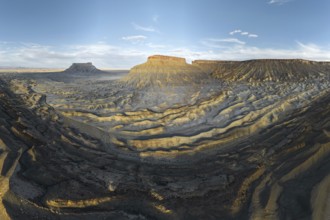 A breathtaking view of the rugged landscape of Caineville Mesa, Utah, USA, captured at sunset The