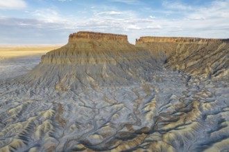 A breathtaking aerial view of Caineville Mesa in Utah, showcasing its impressive striated