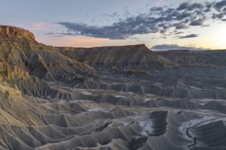 A stunning view of Caineville Mesa, Utah, showcasing dramatic geological formations under a vibrant