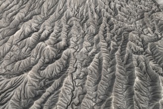 Stunning aerial photograph capturing the intricate, wavy patterns of the eroded land formations at