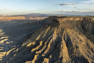 Aerial view of Caineville Mesa, Utah, showcasing dramatic ridges and rocky terrain under a clear