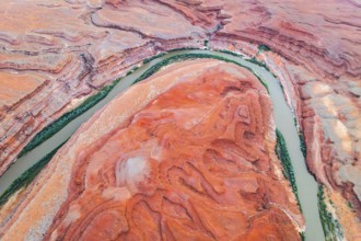 Stunning aerial shot capturing the sinuous Rio San Juan winding through the dramatic red rock
