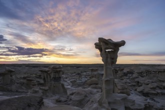 Stunning rock formations under a vibrant sunset sky in Bisti De-Na-Zin Wilderness, New Mexico The