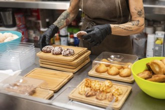 An Italian bakery scene features a person arranging freshly baked pastries on wooden trays The