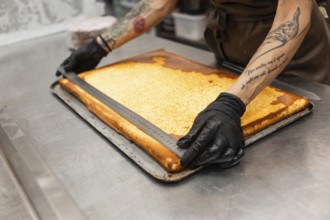 A baker skillfully measures pastry dough, showcasing precision in preparation The scene captures