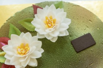 A beautifully decorated Italian cake topped with delicate edible flowers and vibrant leaves Ideal