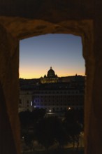 A stunning view of St Peter's Basilica framed by ancient architecture at twilight, with a vibrant