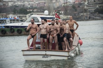 Istanbul, Turkey, January 6th 2017 Swimmers cross themselves and prepare to dive into the Golden